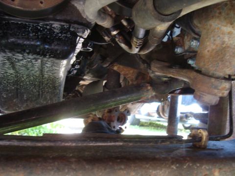 1999 Ford F-150 - Close-up view of the undercarriage of a vehicle, revealing mechanical parts and suspension components.