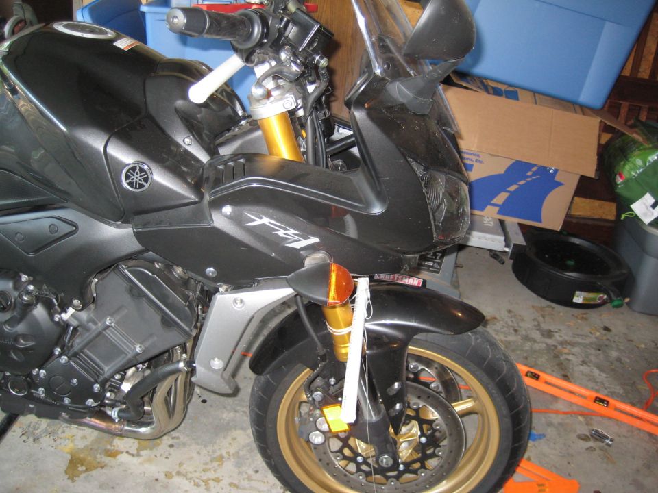 Black motorcycle front view, gold wheels, visible FZ1 badging