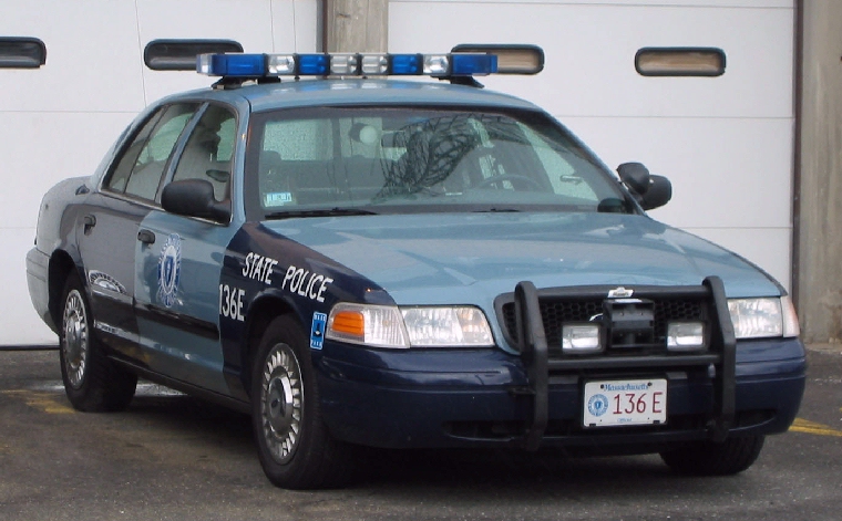 Police car with light bar and push bumper, marked "STATE POLICE 136E"