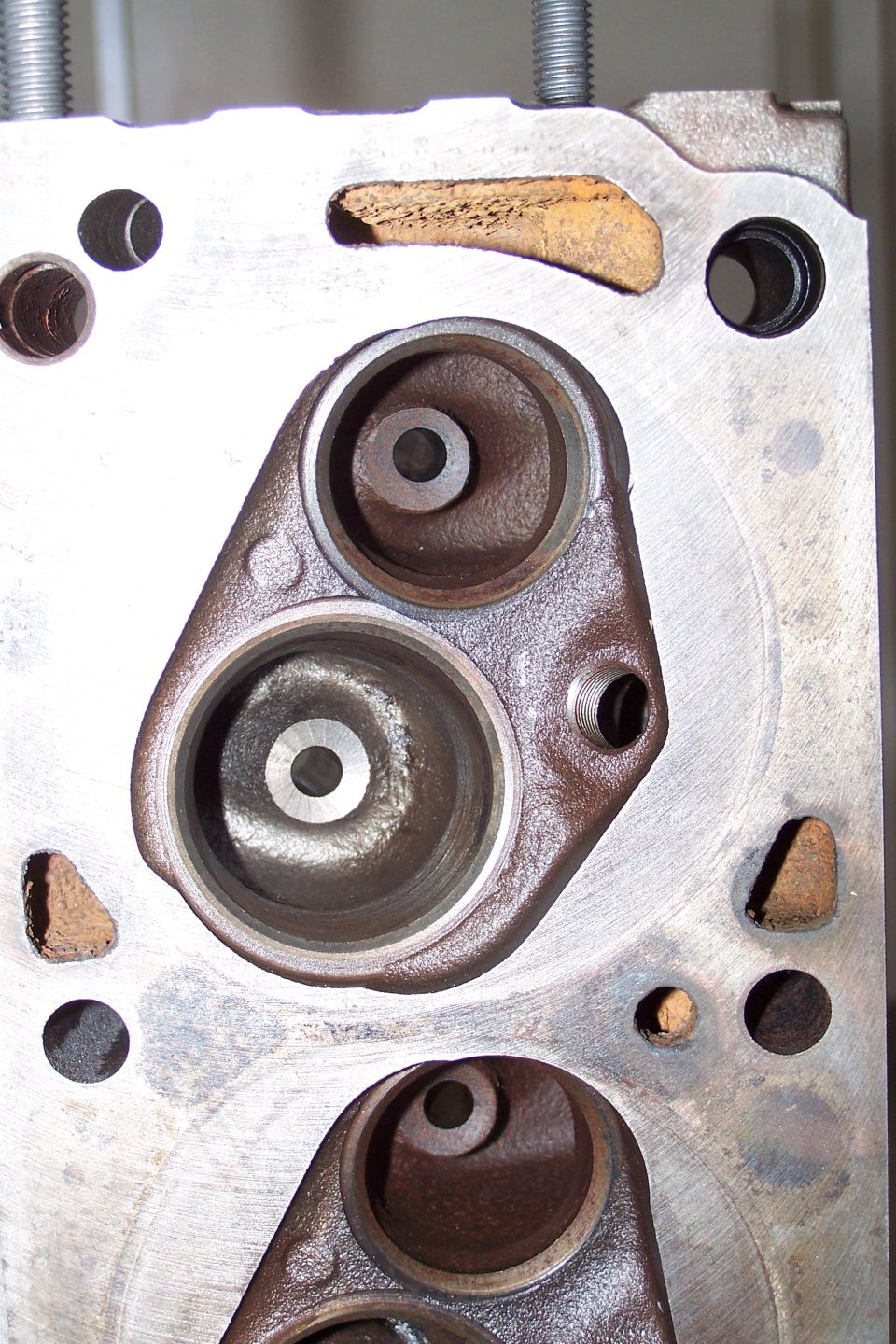 Close-up of an engine cylinder head with two large valve openings
