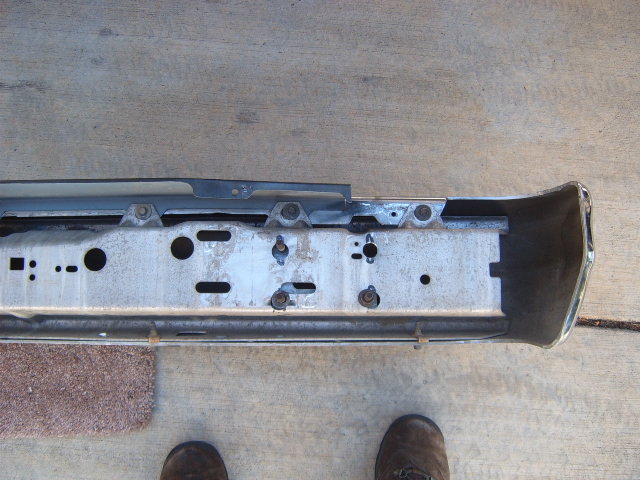 Car bumper assembly with mounting brackets and chrome end cap
