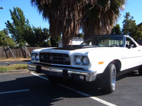 1973 Ford Ranchero - White 1973 Ford Ranchero pickup with a black hood parked outdoors.