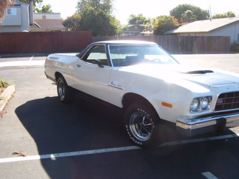 1973 Ford Ranchero - White 1973 Ford Ranchero with black vinyl top and hood scoop.
