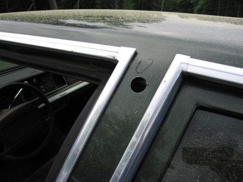1991 Ford LTD Crown Victoria - Close-up of a car's interior, focusing on the dashboard and door frame details.