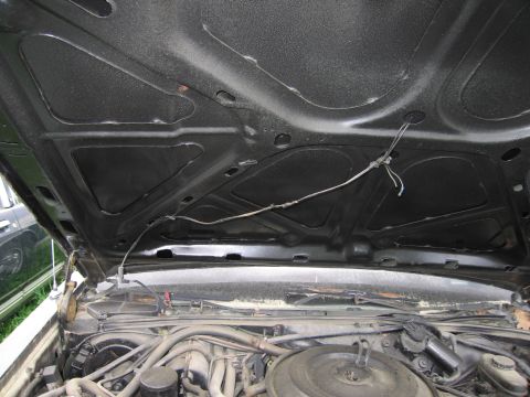 1991 Ford LTD Crown Victoria - View under the hood of a car, showing the underside of the hood and engine bay.