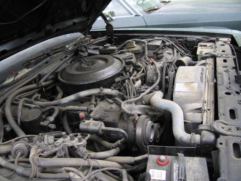 1991 Ford LTD Crown Victoria - The engine bay of a vehicle, showing various mechanical parts and wiring.