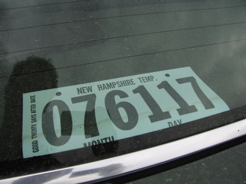 1991 Ford LTD Crown Victoria - New Hampshire temporary paper registration tag displayed in a vehicle's rear window, not a technical document.