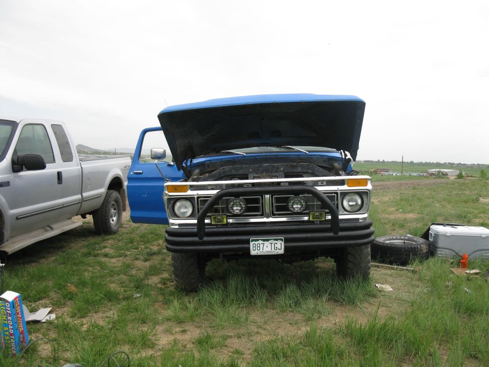 1977 Ford F-250 front view, blue, hood open, bull bar