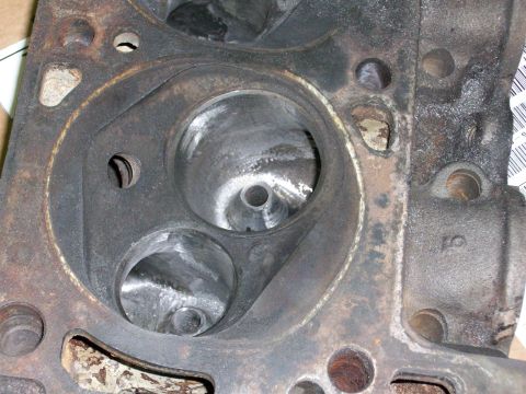 1973 Ford Ranchero - Close-up of an engine cylinder head, revealing internal combustion chamber details and signs of use.