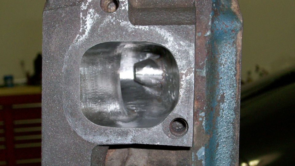 Close-up of an engine cylinder head port with visible casting marks