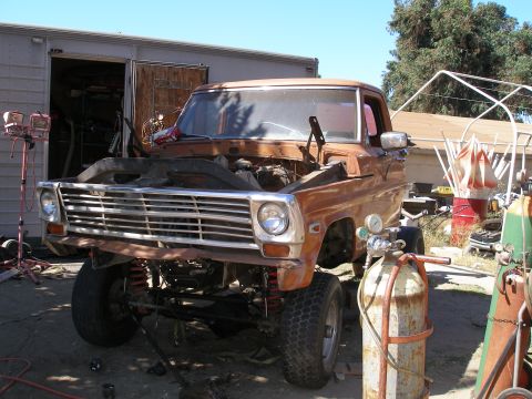 1969 Ford F-250 - This rusty Ford F-series pickup truck appears to be undergoing repairs or modifications.