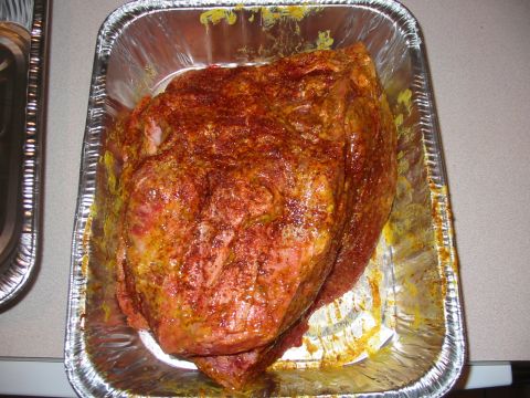 1992 Ford Bronco - A piece of raw meat seasoned with spices sits in a foil pan, ready for cooking.