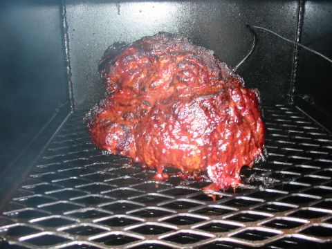 1992 Ford Bronco - Smoked meat on a grill rack inside a smoker, with a temperature probe visible.
