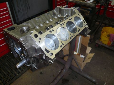 1975 Ford Ranchero - A bare engine block is shown on a stand, ready for assembly or repair in a workshop setting.