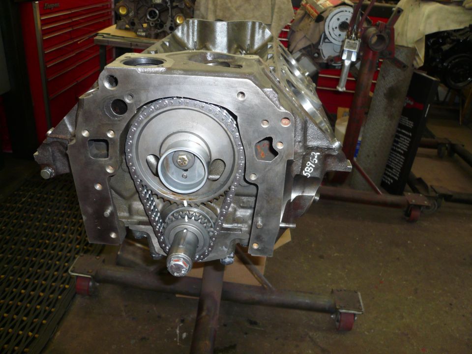 Engine block on stand with timing chain and gears visible