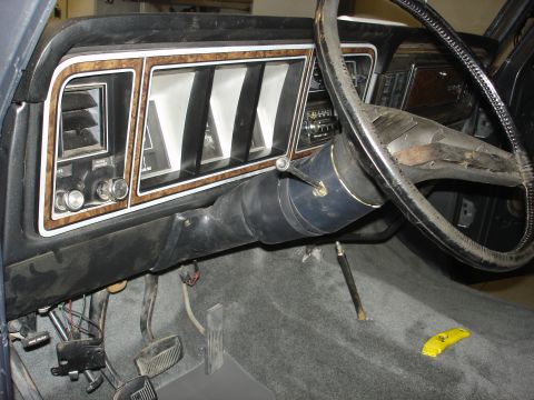 1979 Ford F-250 - Interior view of a 1979 Ford F-250, highlighting the dashboard's woodgrain trim and steering wheel.