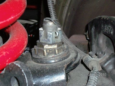 1996 Ford Bronco - A close-up view of a vehicle's suspension component, a red coil spring and a date stamp of 05.30.2010.