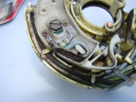 1973 Ford Ranchero - This image shows a close-up view of a damaged electrical component, exposed copper wiring and a worn plastic casing.