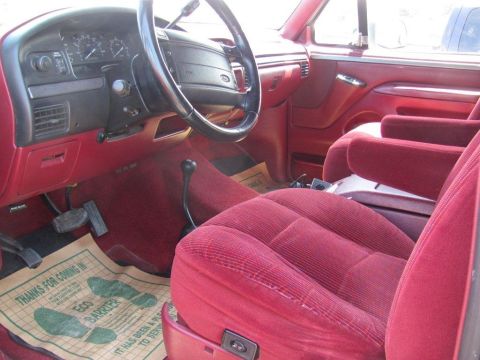 1995 Ford Bronco - Interior view of a 1995 Ford Bronco, showing the seats, dashboard, and floor mat.