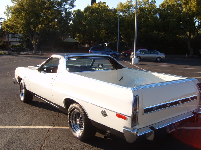 1973 Ford Ranchero parked, rear 3/4 view. Cream exterior, black vinyl top