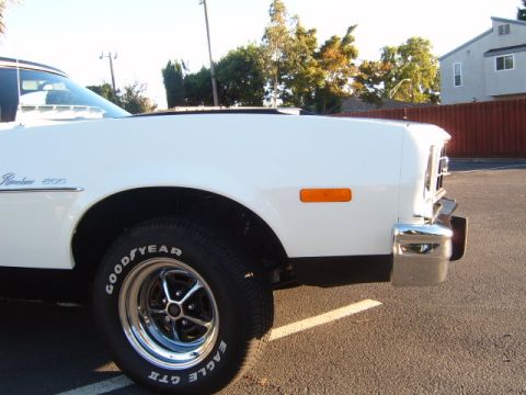 1973 Ford Ranchero - Close-up of the front fender and wheel of a white 1973 Ford Ranchero 500.