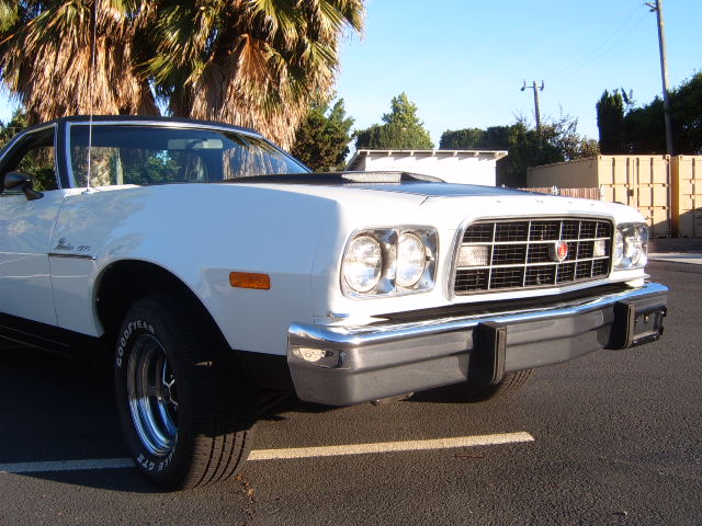 White 1977 Ford Ranchero front quarter view, showing grille, headlights, and bumper
