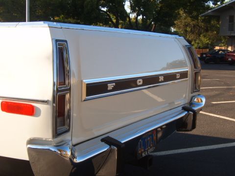 1973 Ford Ranchero - Rear view of a white 1973 Ford Ranchero, showing the tailgate lettering and chrome bumper.