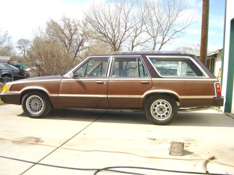 1984 Ford LTD - This station wagon features wood grain paneling along its side and a roof rack.