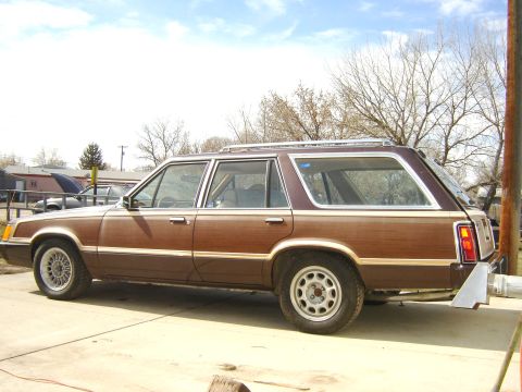 1984 Ford LTD - This station wagon, likely from the early 1980s, has wood paneling and a roof rack.