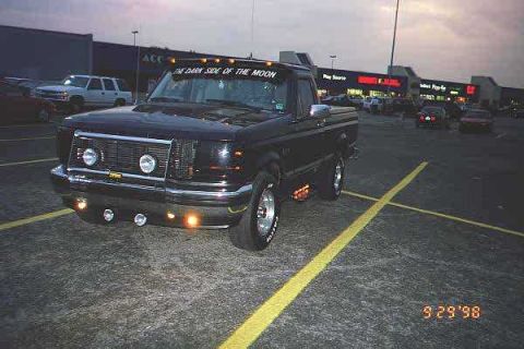 1994 Ford F-150 - This 1994 Ford F-150 pickup truck is parked in a lot, with custom text on the visor.