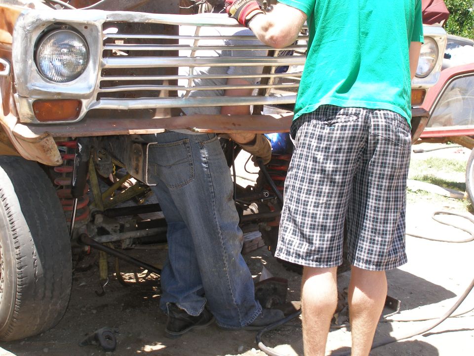 Truck front end being worked on, showing grille and headlight