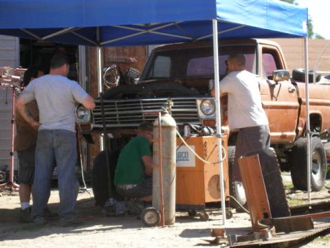 1969 Ford F-250 - People are working on the front of a 1967 Ford F-series truck.
