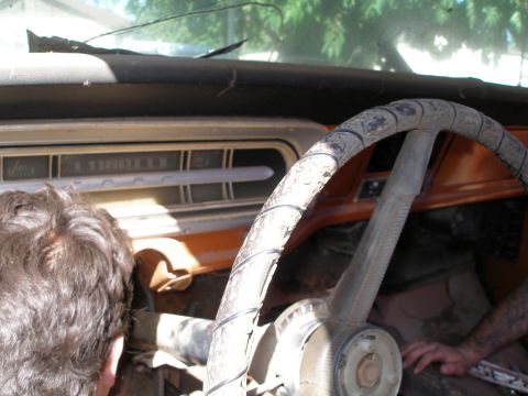 1969 Ford F-250 - Dashboard and steering wheel of a 1967 Ford F-Series truck, showing wear and tear.