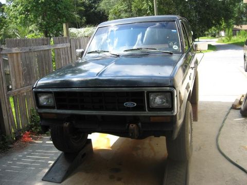 1985 Ford Bronco II - Front view of a 1985 Ford Bronco II parked on ramps in a driveway.