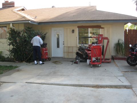 1969 Ford F-250 - Engine removal in progress with an engine hoist and a red toolbox cart.