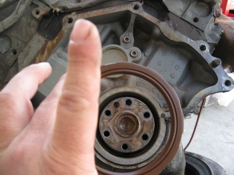 1969 Ford F-250 - Engine block detail with crankshaft seal visible, a thumb is in the foreground.