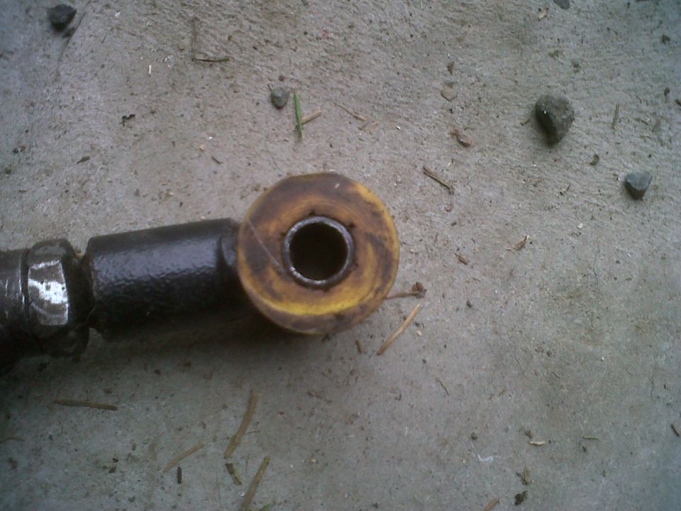 Suspension part with yellow bushing and black metal rod