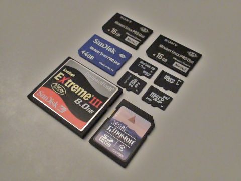 1993 Ford Taurus - A variety of digital storage memory cards are laid out on a neutral surface.