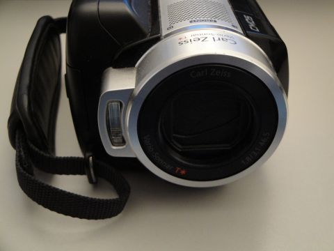 1993 Ford Taurus - A camcorder with a Carl Zeiss lens is shown from the front, with a black strap attached.