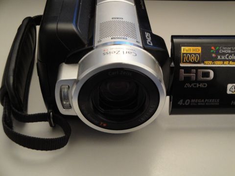 1993 Ford Taurus - A camcorder with a Carl Zeiss lens is shown, displaying its HD and megapixel specifications.