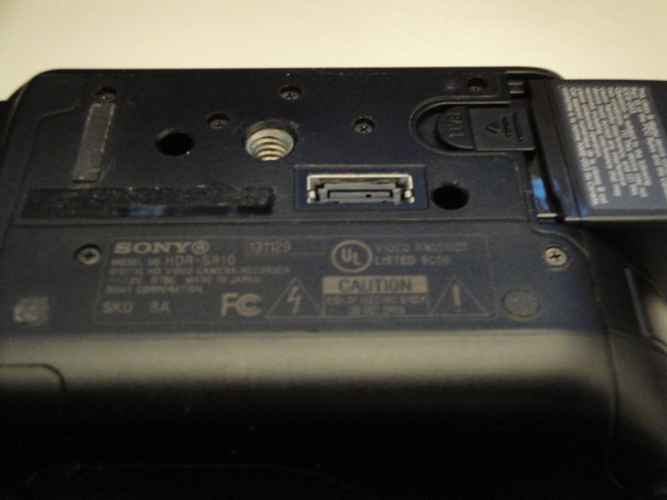 Bottom of Sony HDR-SR10 digital video camera showing ports and labels
