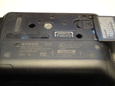 1993 Ford Taurus - Sony HDR-SR10 video camera bottom with model and caution labels visible.