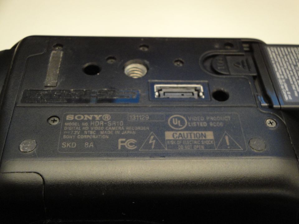 Back of a Sony HDR-SR10 digital HD video camera recorder showing model and caution labels