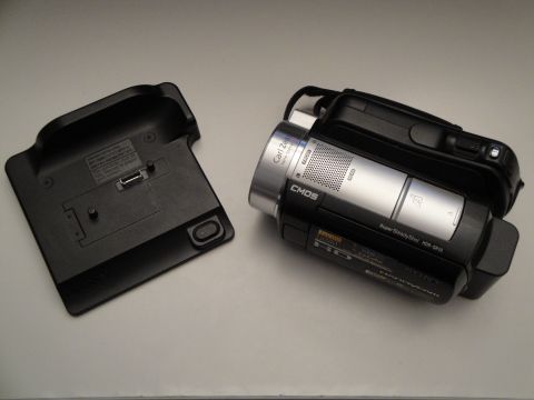 1993 Ford Taurus - A Sony Handycam camcorder and its charging dock are shown on a flat surface.