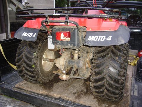 1989 Yamaha MOTO-4 - Rear view of a red ATV with MOTO-4 branding, loaded in the bed of a truck.
