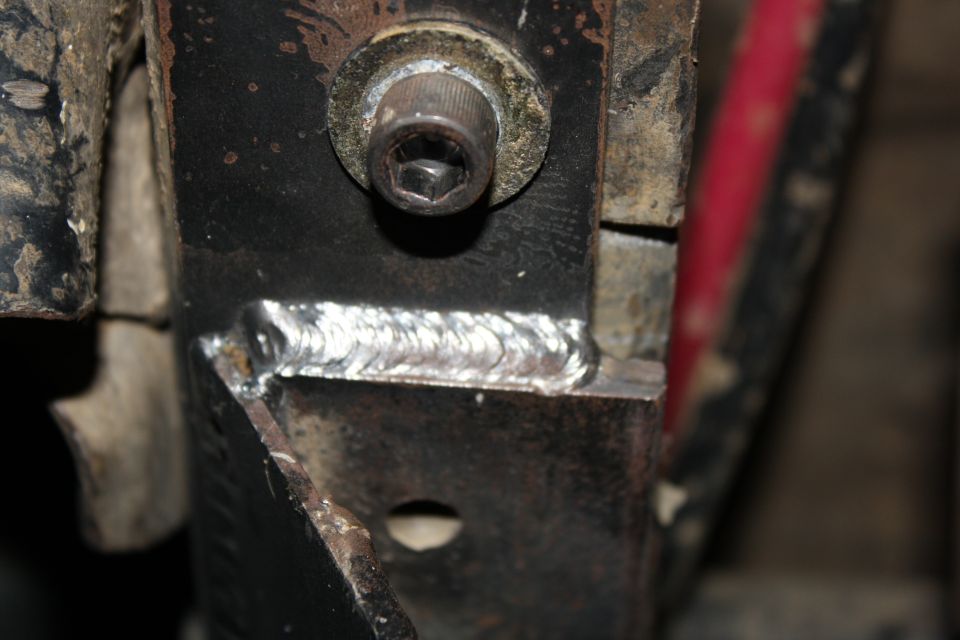 Welded metal bracket with hex bolt, close-up view