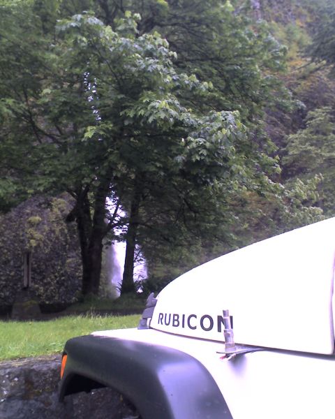 2005 Jeep Wrangler - A white Jeep Wrangler is parked in a natural setting with a waterfall visible in the background.