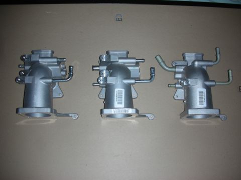 2004 Ford Crown Victoria - Three intake manifolds are displayed, each with attached hoses and visible labels.