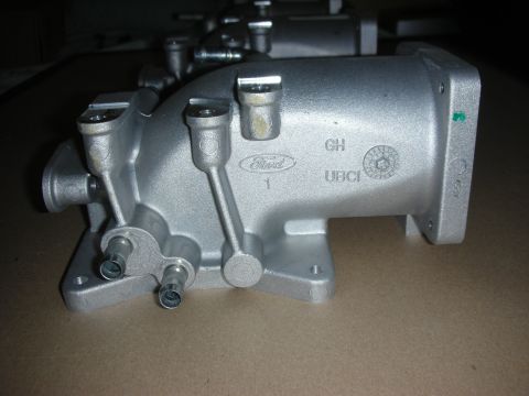 2004 Ford Crown Victoria - Close-up of a Ford branded intake manifold part, likely for an engine.
