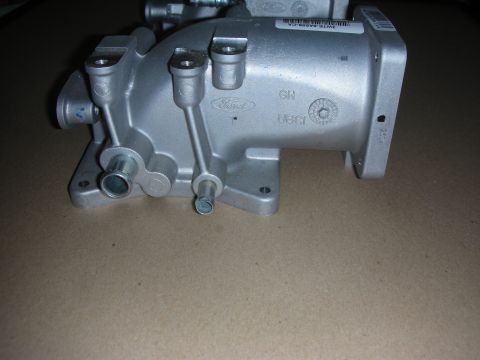 2004 Ford Crown Victoria - Close-up of a silver Ford intake manifold part with various markings and ports.